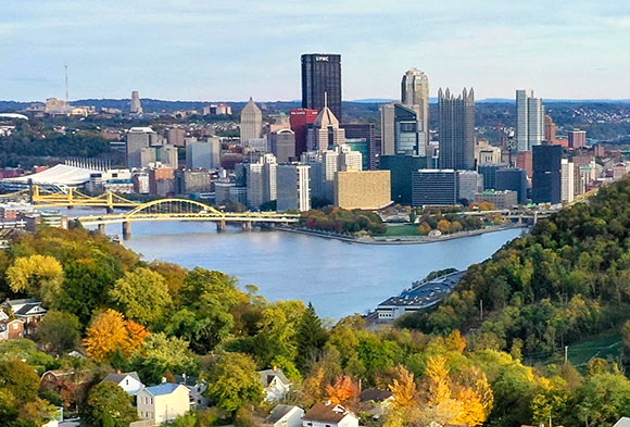 Pittsburgh skyline with neighborhood in the foreground.